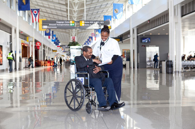 staff assisting person in a wheelchair